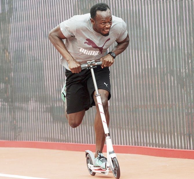  Sprinter Usain Bolt of Jamaica rides a scooter