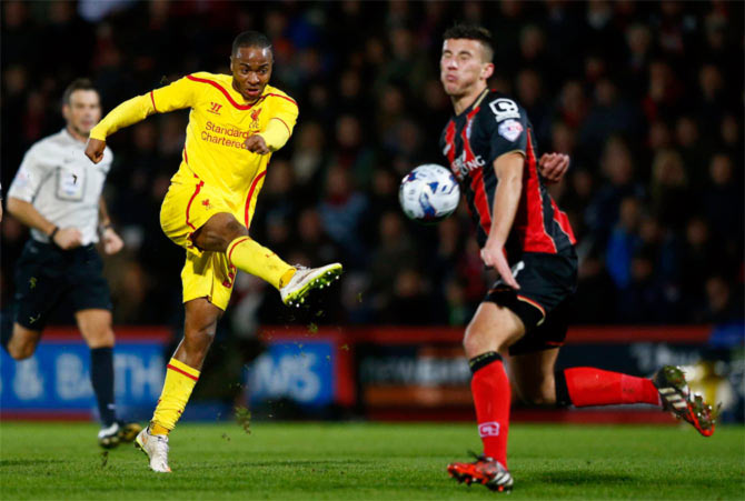 Raheem Sterling (left) of Liverpool shoots past Baily Cargill of Bournemouth