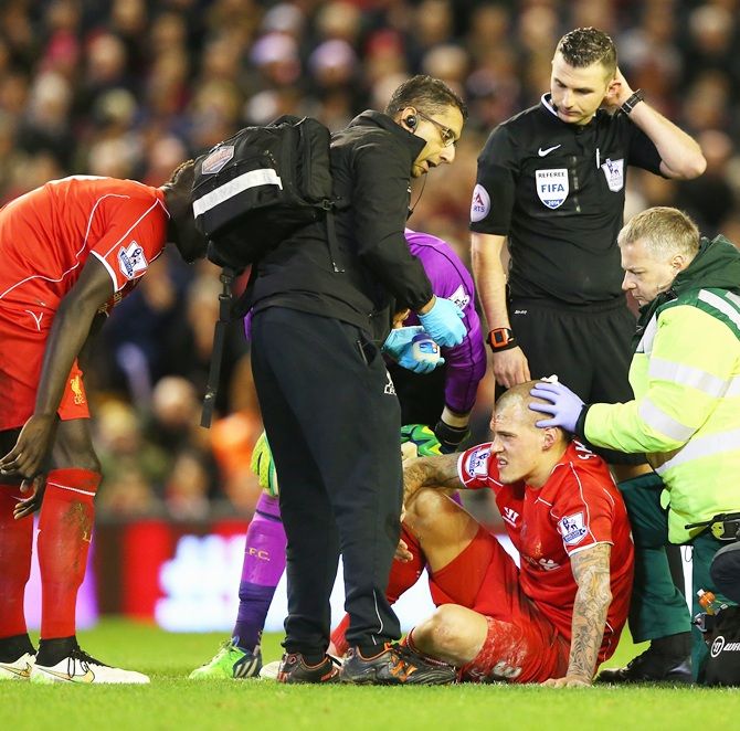 Martin Skrtel of Liverpool receives treatment for a head wound