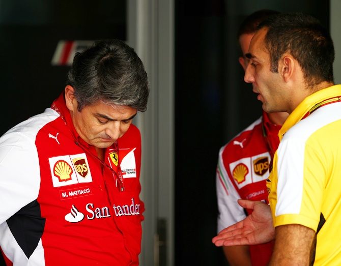 Ferrari Team Principal Marco Mattiacci speaks with Renault's Cyril Abiteboul in the paddock