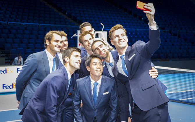Tomas Berdych of the Czech Republic takes a group selfie of Stan Wawrinka of Switzerland,Milos Raonic of Canada,Novak Djokovic of Serbia,Kei Nishikori of Japan,Andy Murray of Great Britain,Roger Federer of Switzerland and Marin Cilic of Croatia after the mens singles official group shot had been taken prior to the start of the Barclays ATP World Tour Finals tennis previews at the O2 Arena