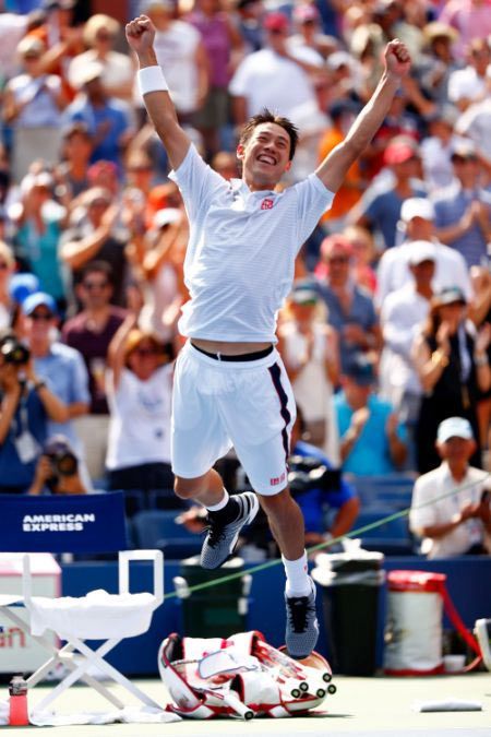 Kei Nishikori of Japan celebrates after defeating Novak Djokovic of Serbia in their men's singles semi-final
