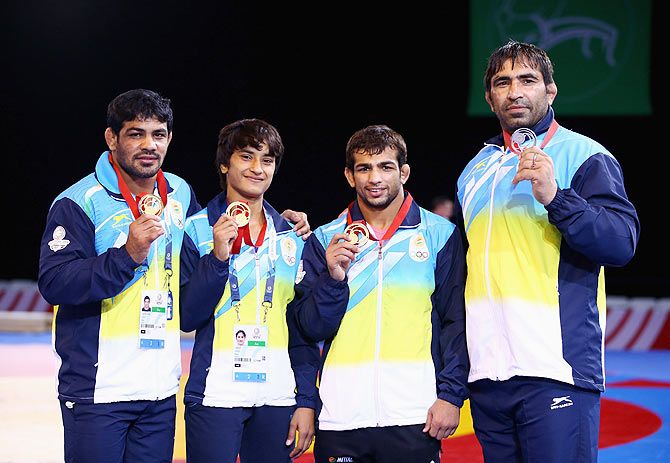 Indian medalists Sushil Kumar (gold 74kg) Vinesh (gold 48kg) Amit Amit Kumar (gold 57kg) and Rajeev Tomar (silver 125kg) pose with their medals after the Freestyle Wrestling finals at Scottish Exhibition And Conference Centre during the Glasgow 2014 Commonwealth Games on July 29