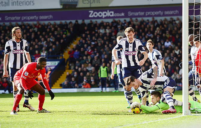 Kolo Toure of Liverpool reacts as goalkeeper Ben Foster of West Bromwich saves his shot on goal during their Premier League match at The Hawthorns in West Bromwich on Sunday