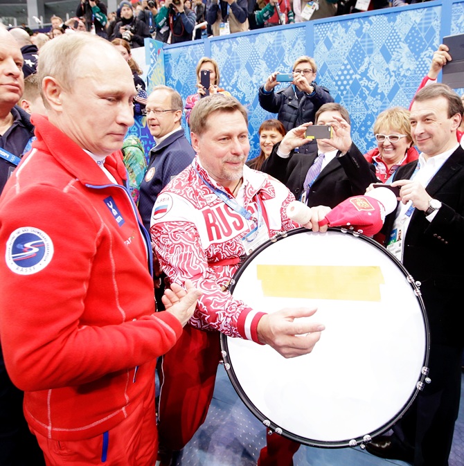 Russian President Vladimir Putin walks through the arena after the Flower Ceremony for the Team Figure Skating