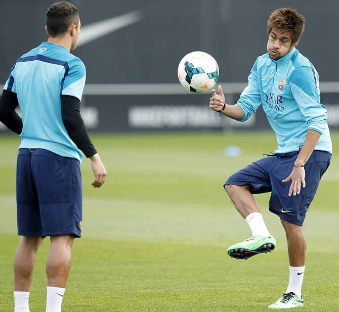 Barcelona's Neymar, right, and Adriano Correia take part in a training session.