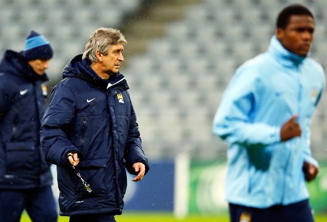 Manchester City's manager Manuel Pellegrini, centre, conducts a training session.