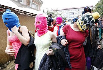 Masked members of protest band Pussy Riot leave a police station in Adler during the 2014 Sochi Winter Olympics on Tuesday