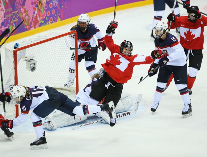Marie-Philip Poulin of Canada celebrates after scoring against Jessie Vetter of the United States during the Ice Hockey Women's Gold Medal Game.