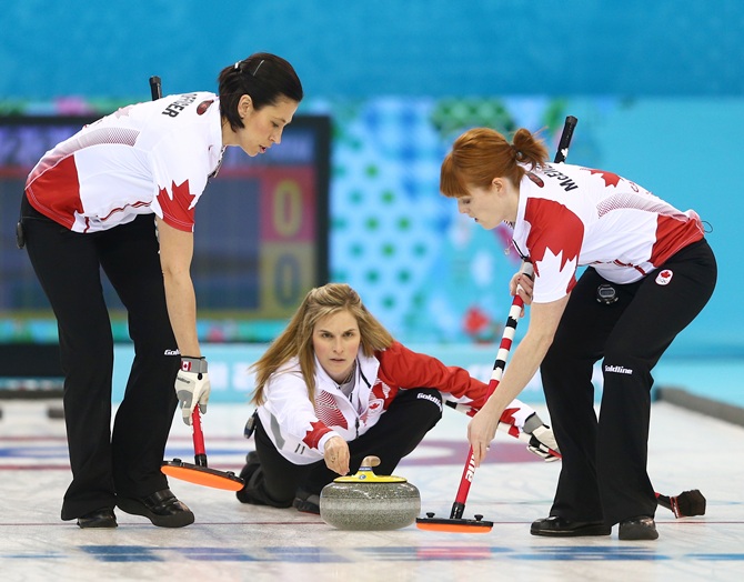 Jennifer Jones of Canada releases the stone during the women's semifinal match between Great Britain and Canada at Ice Cube Curling Center.