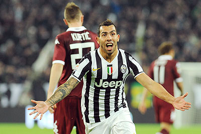 Carlos Tevez of Juventus celebrates after scoring the opening goal during the Serie A match between Juventus and Torino FC at Juventus Arena in Turin on Sunday