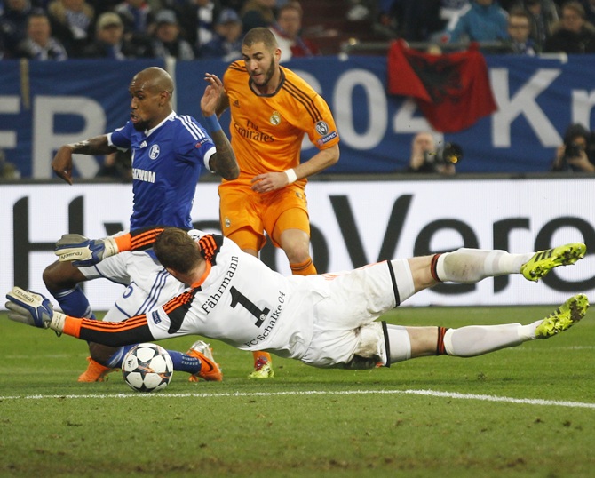 Real Madrid's Karim Benzema, right, scores a goal against Schalke 04.