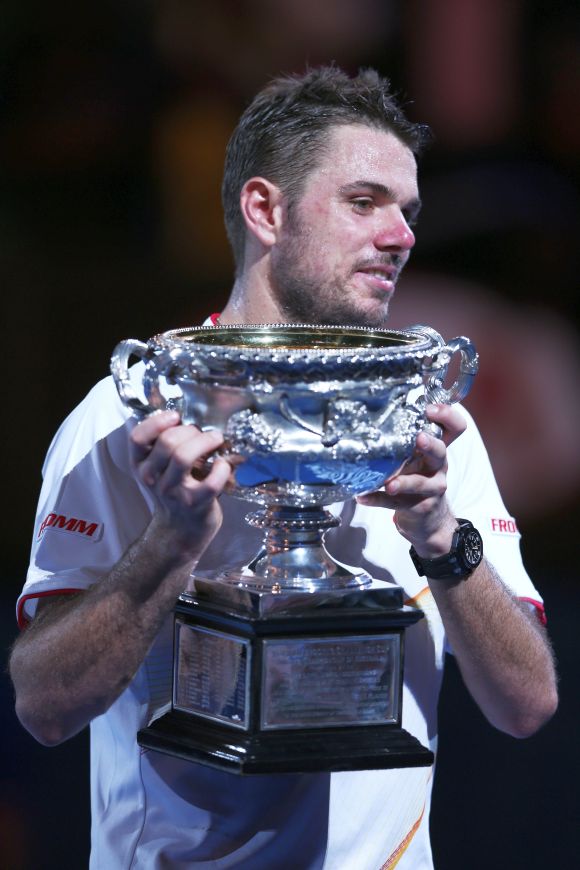 Stanislas Wawrinka of Switzerland holds the Norman Brookes Challenge Cup after winning his men's final match against Rafael Nadal of Spain.