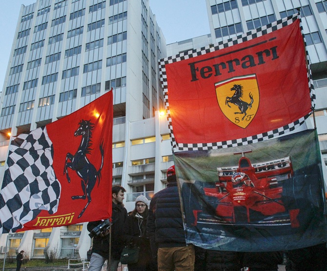 Ferrari flags are seen in front of the CHU Nord hospital emergency unit in Grenoble, French Alps, where Michael Schumacher is hospitalized after a ski accident