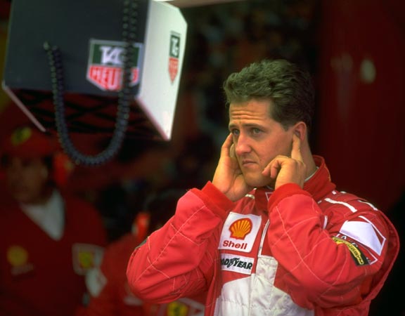 Michael Schumacher and the Ferrari team study qualifying times for the French GP. Schumacher went on to win the race, June 28, 1997.
