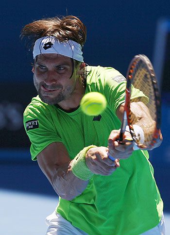 David Ferrer of Spain hits a return to Alejandro Gonzalez of Colombia during their men's singles match at the Australian Open in Melbourne on Monday