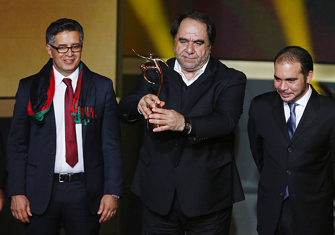 Afghanistan Football Federation President Karim Keramuddin (centre) holds the trophy after the Afghanistan Football Federation received the FIFA Fair Play award on Monday
