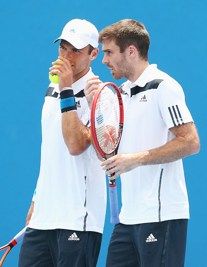 Ross Hutchins of Great Britain talks tactics with Colin Fleming of Great Britain during their first round doubles match against Marinko Matosevic of Australia and Michal Przysiezny of Poland on Wednesday