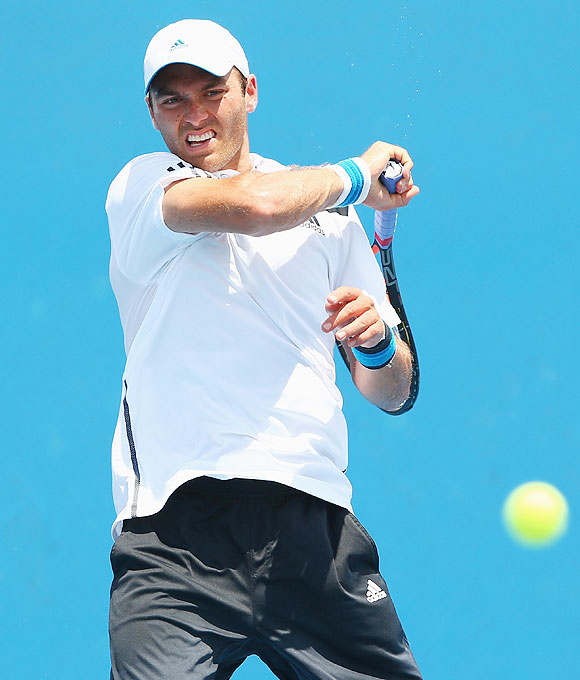 Ross Hutchins of Great Britain plays a forehand in his first round doubles match with Colin Fleming of Great Britain against Marinko Matosevic of Australia and Michal Przysiezny of Poland on Wednesday