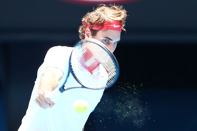 Roger Federer of Switzerland plays a backhand in his third round match against Teymuraz Gabashvili of Russia at the Australian Open at Melbourne Park on Sunday