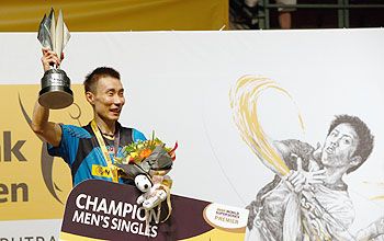 Lee Chong Wei of Malaysia celebrates with the Champions Trophy after he defeated Tommy Sugiarto of Indonesia in the final of the Malaysia Badminton Open in Kuala Lumpur, on Sunday