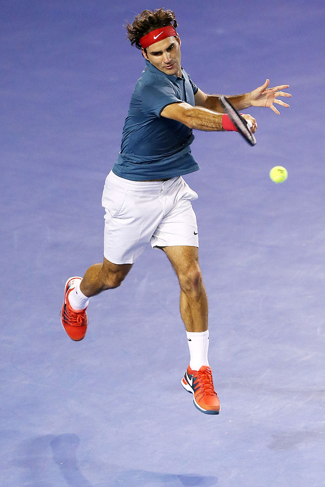 Roger Federer plays a forehand against Rafael Nadal