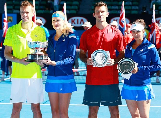 Kristina Mladenovic of France and Daniel Nestor of   Canada pose with the winners trophy, and Sania Mirza of   India and Horia Tecau of Romania pose with the runner up trophy