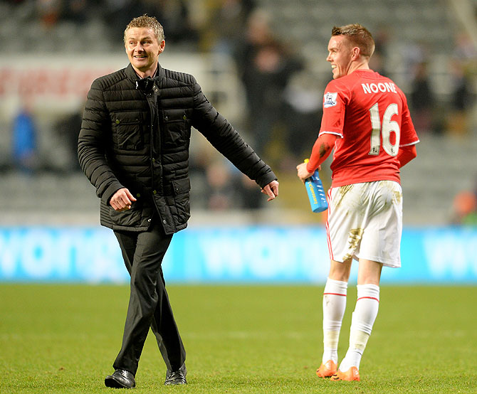 Ole Gunnar Solskjaer the Cardiff manager celebrates with Craig Noone of Cardiff