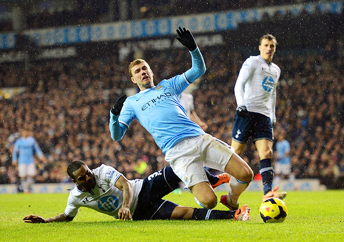 Danny Rose of Tottenham Hotspur (left) fouls Edin Dzeko of Manchester City in the box