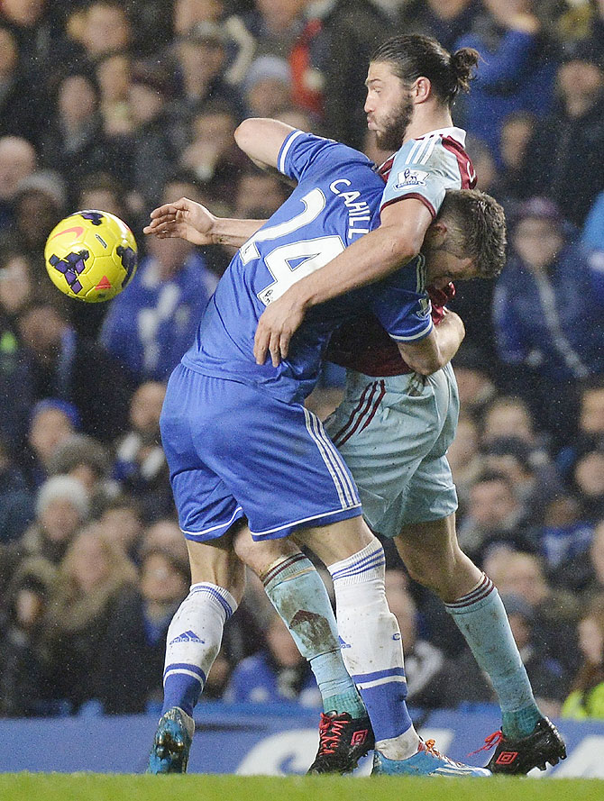 Chelsea's Gary Cahill (left) challenges West Ham United's Andy Carroll during their English Premier League match at Stamford Bridge on Wednesday