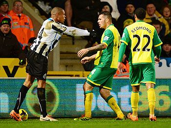 Loic Remy of Newcastle United and Bradley Johnson of Norwich City come to blows during their English Premier League match at Carrow Road in Norwich, England on Tuesday
