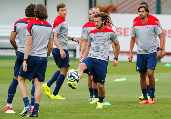 Kyle Beckerman of the United States runs drills during their training session