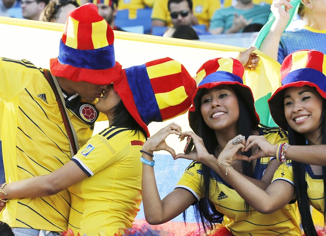 Fans of Colombia gesture as they wait for the start of their 2014 World Cup soccer match