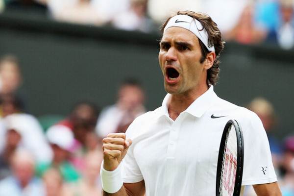 Roger Federer celebrates after beating countryman Stanislas Wawrinka