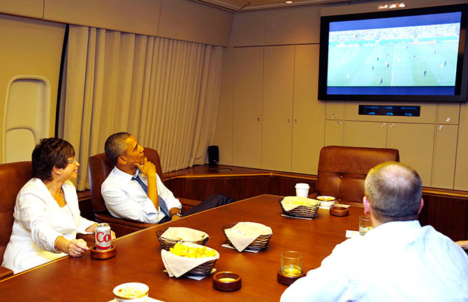   US President Barack Obama and his senior advisor Valerie Jarrett (left) the World Cup match between US and Germany while aboard Air Force One on their way to Minnesota