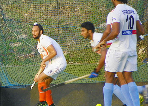 Sardar Singh and V Raghunath go through a penalty-corner drill in training