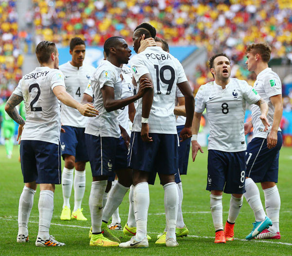 Paul Pogba of France celebrates with teammates after scoring his team's first goal against Nigeria