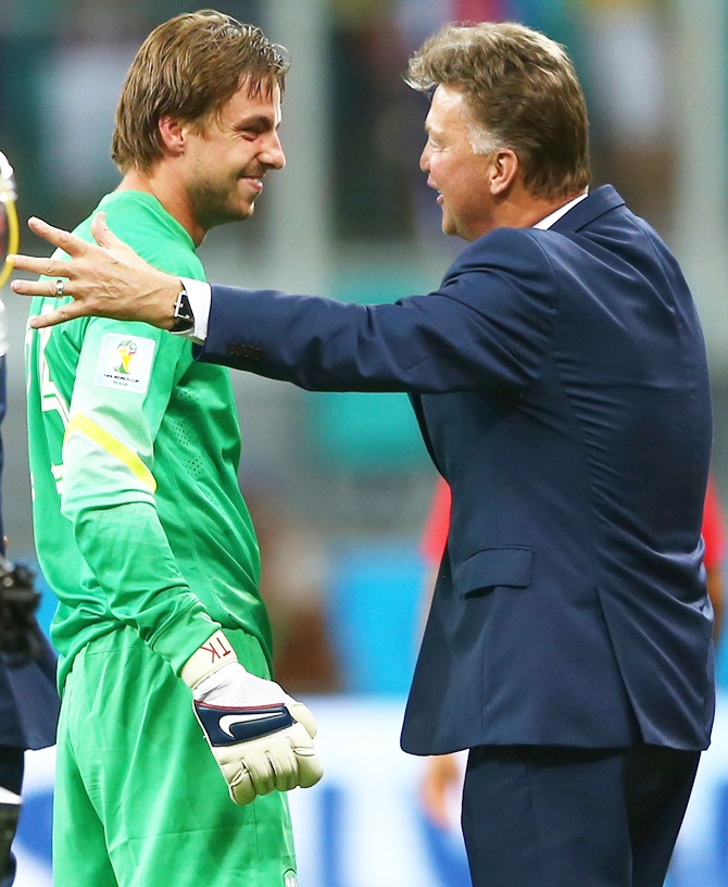Goalkeeper Tim Krul of the Netherlands celebrates with head coach Louis van Gaal