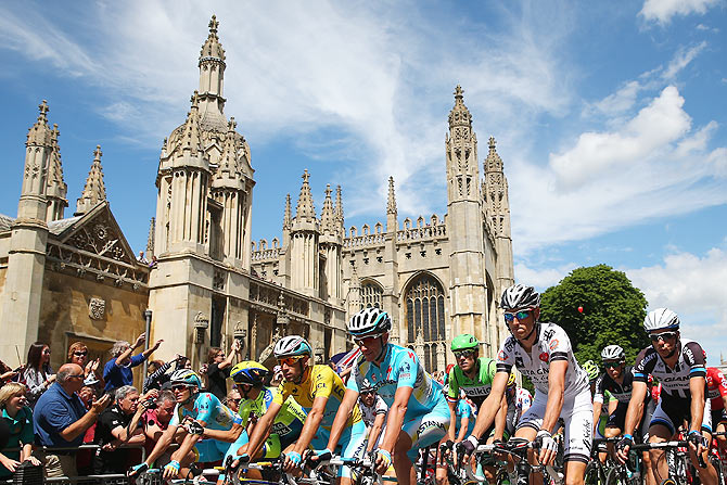 The peloton rides past Cambridge University at the start of the third stage of the 2014 Tour de France, a 155km stage between Cambridge and London, on Monday