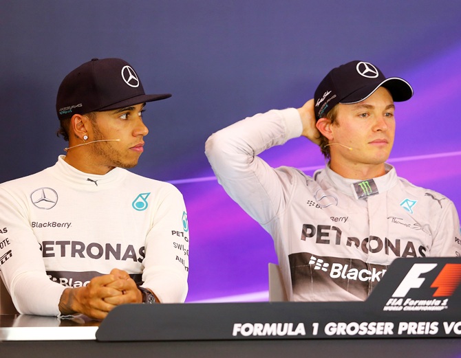 Nico Rosberg, right, of Germany and Mercedes GP sits next to Lewis Hamilton of Great Britain