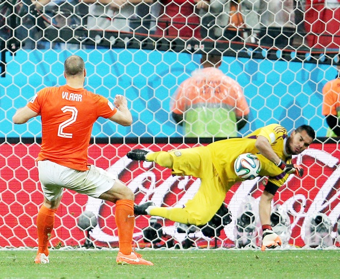 Sergio Romero of Argentina saves the penalty kick of Ron Vlaar of the Netherlands