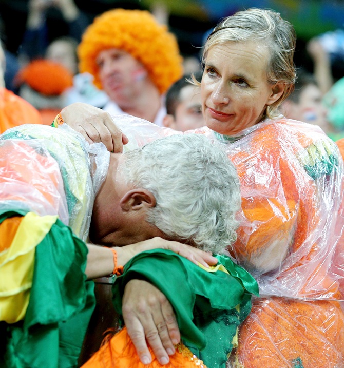 A dejected the Netherlands fan looks on after being defeated by Argentina in a penalty shootout