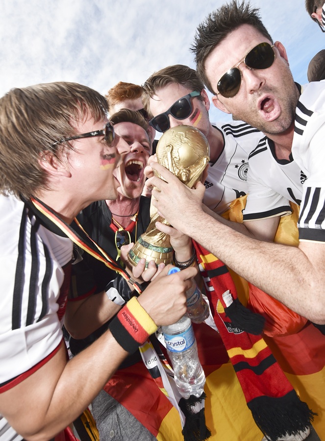 German fans pose with a replica of World Cup trophy