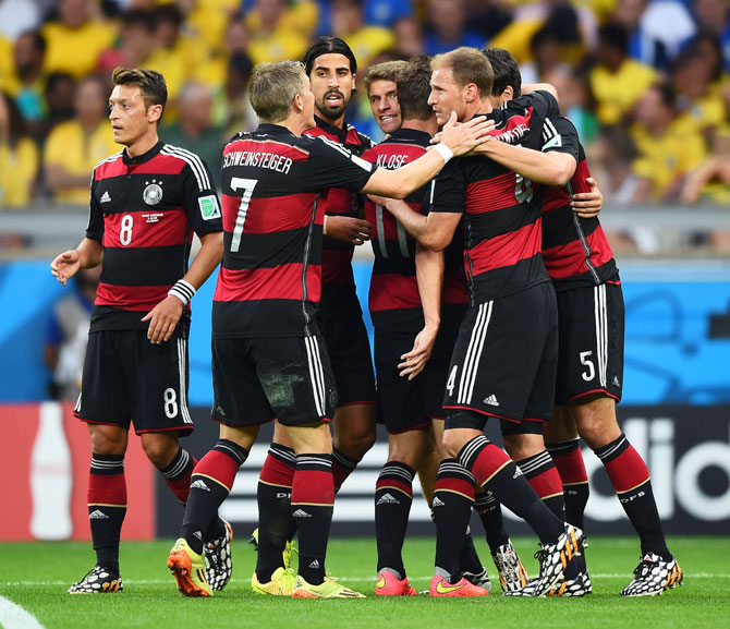 Thomas Mueller of Germany celebrates scoring his team's first goal with teammates