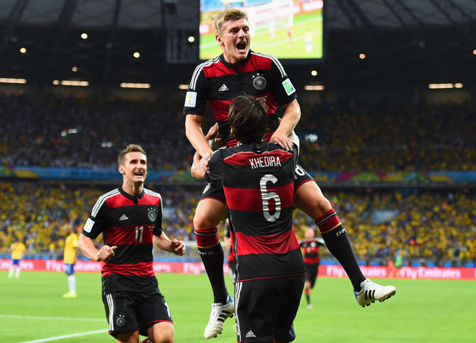 Toni Kroos of Germany celebrates scoring his team's third goal with teammates Miroslav Klose (left) and Sami Khedira