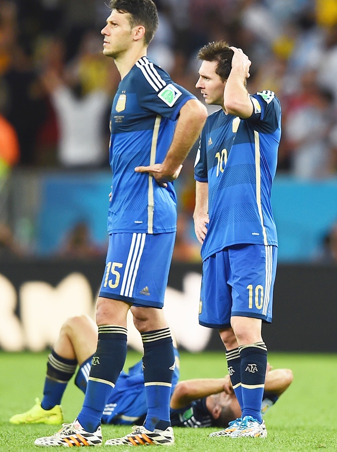 Martin Demichelis, left, and Lionel Messi of Argentina look on after being defeated by Germany 1-0