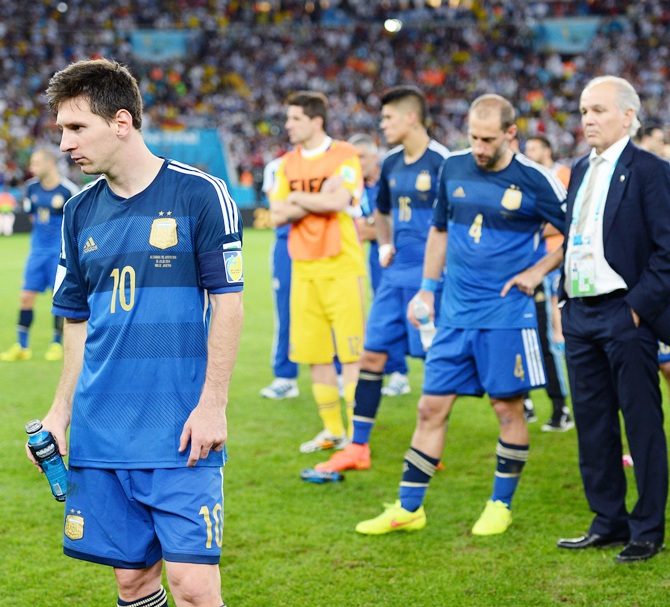 A dejected Lionel Messi of Argentina looks on with his team