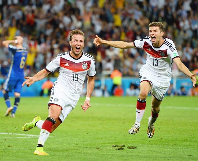Mario Goetze of Germany, left, celebrates scoring his team's goal with Thomas Mueller