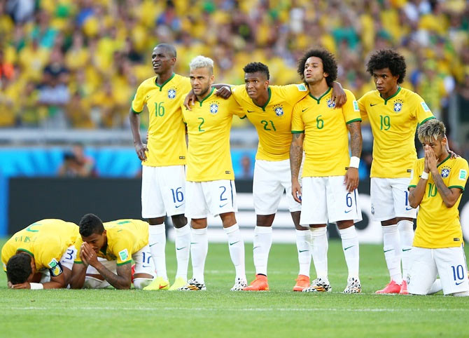 Thiago Silva, Luiz Gustavo, Ramires, Dani Alves, Jo, Marcelo, Hulk, Willian and   Neymar of Brazil look on during a penalty shootout against Chile