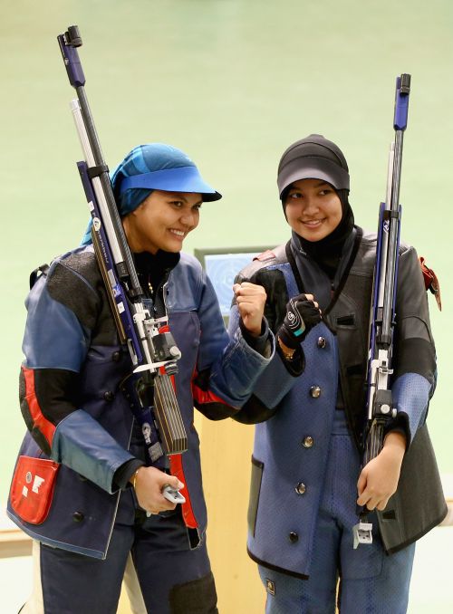 Bronze medalist Nur Suryani Mohamed Taibi (L) and Silver medalist Nur Ayuni Halim (R)   pose after the Womens 10m air rifle singles event at the Dr Karni Singh Shooting Range